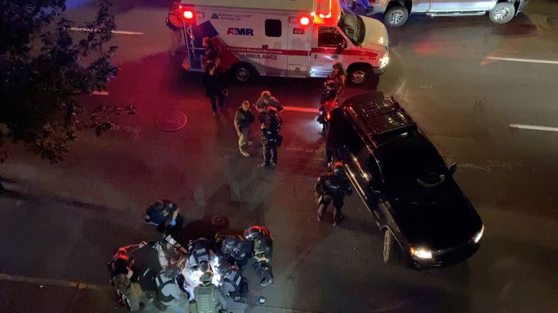 FILE PHOTO: Video grab of medics and police personnel with the victim of a shooting in Portland, U.S.