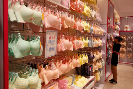 A sales representative works at Cosmo Lady lingerie store in the southern Chinese city of Shenzhen, China July 15, 2016. Picture taken July 15, 2016. REUTERS/Bobby Yip