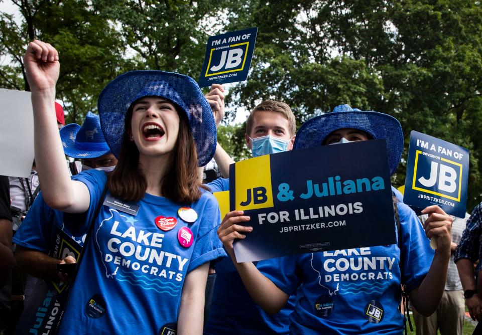 Kelsey Marx, left, joins her fellow members of the Lake County Democrats as they listen to IGov. JB Pritzker during Governor's Day at the Illinois State Fair on the Director's Lawn on Aug. 18, 2021. [Justin L. Fowler/The State Journal-Register]