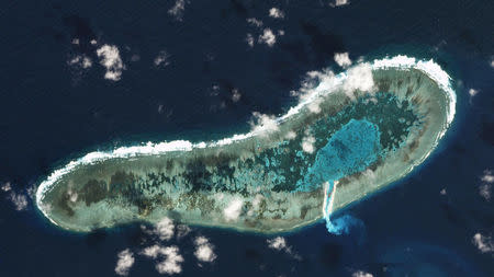 Sand can be seen spilling from a newly dredged channel in this view of Vietnamese-held Ladd Reef, in the Spratly Island group in the South China Sea, November 30, 2016, in this Planet Labs handout photo received by Reuters on December 6, 2016. Trevor Hammond/Planet Labs/Handout via Reuters