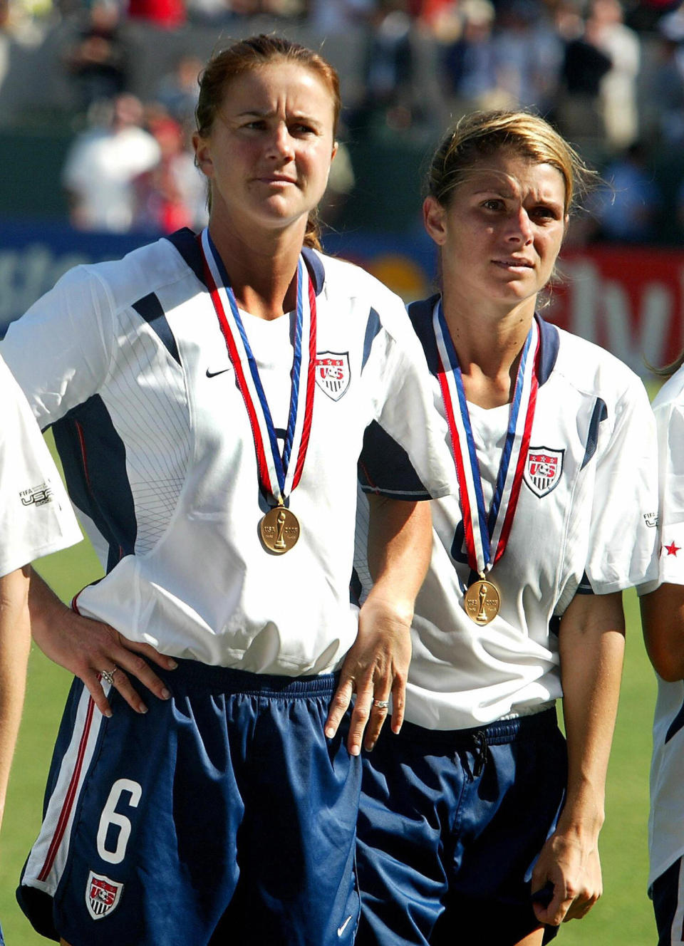 Mia Hamm and Brandi Chastain wearing medals at the FIFA 2003 Women's World Cup third-place match. (Robyn Beck / AFP via Getty Images)