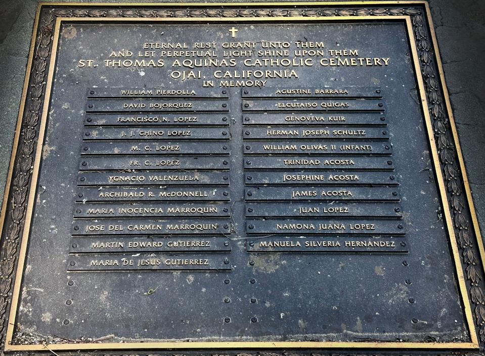 A plaque lists the names of 23 people known to be buried at St. Thomas Aquinas Cemetery near Ojai. The old graveyard lacks full burial records.