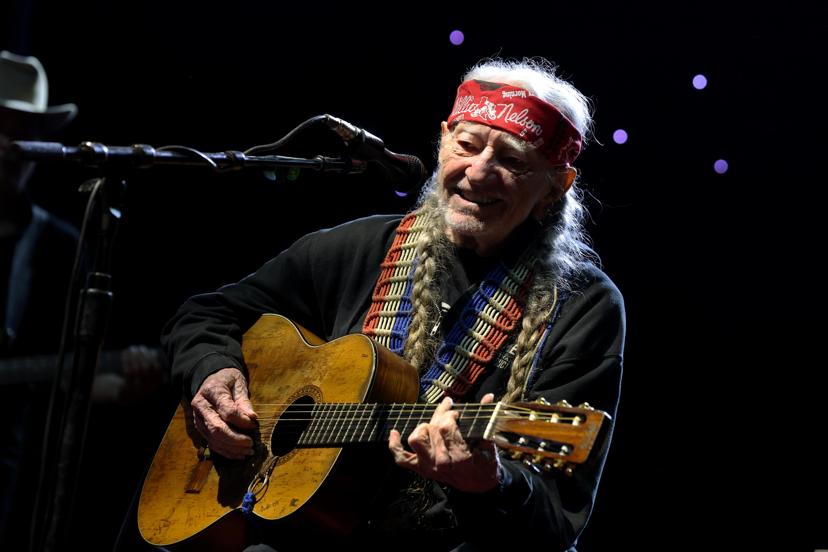 Willie Nelson smiles as he performs onstage in Texas.