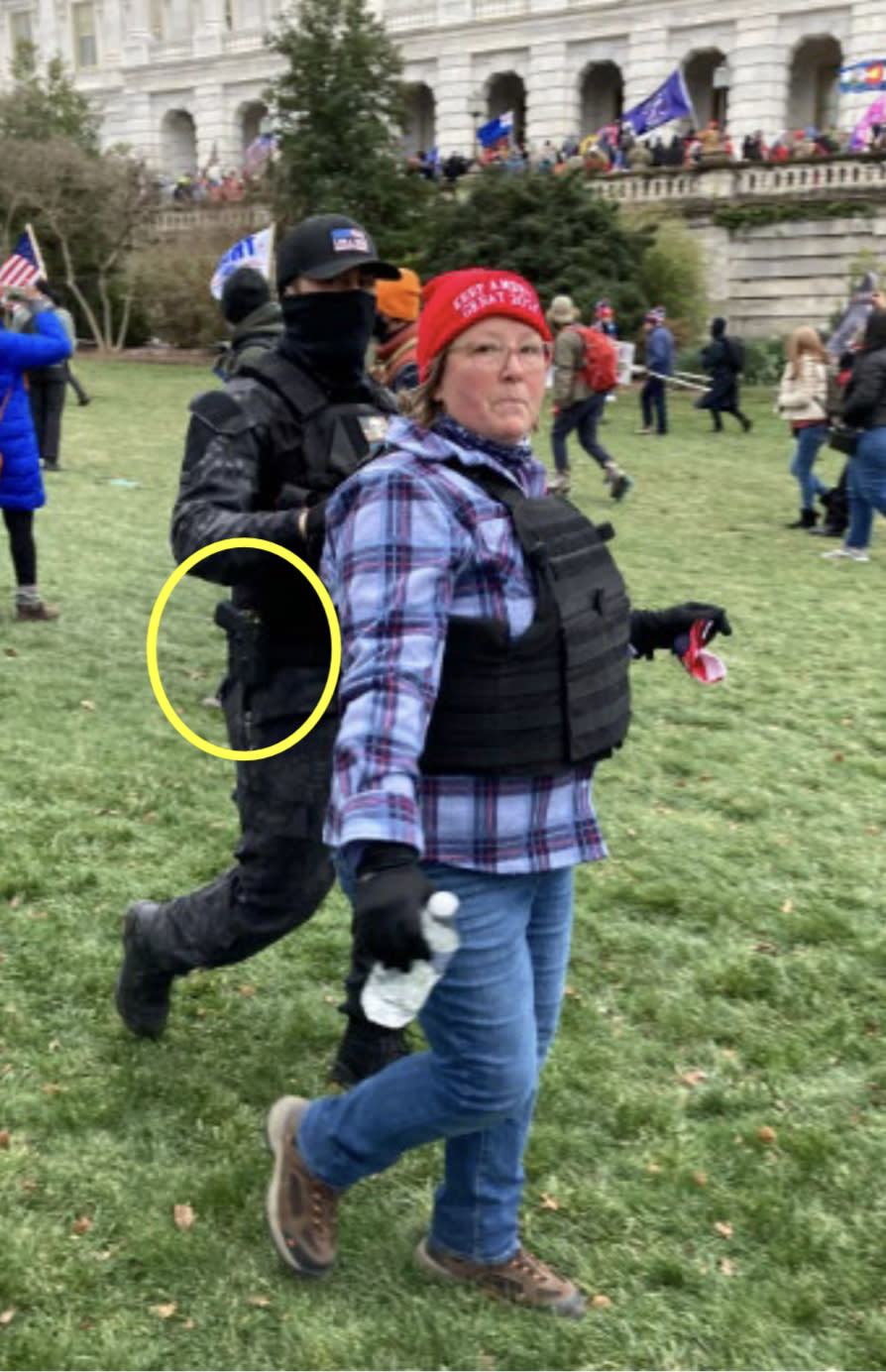 Image 2: photo showing Munchel and Eisenhart wearing tactical vests on the grounds of the U.S. Capitol, with Munchel’s Taser circled in yellow (Exhibit 401)