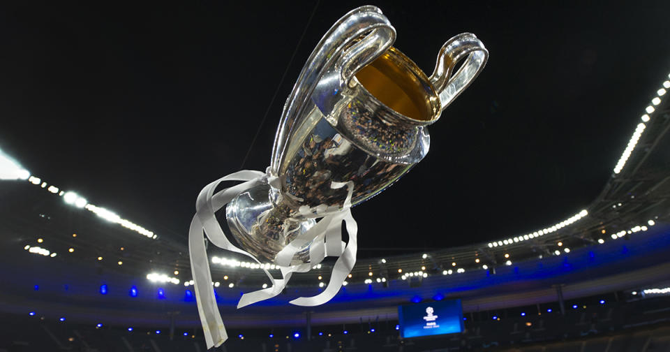   The Champions League trophy is thrown in the air after the UEFA Champions League final match between Liverpool FC and Real Madrid at Stade de France on May 28, 2022 in Paris, France. 