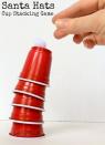 <p>Grab a handful of red solo cups and white pom-poms for this suspenseful stacking game. See how many "Santa hats" you can stack on top of one another before your tower topples over. </p><p><em><a href="https://lalymom.com/christmas-games-kids-santa-hats-cup-stacking-game/" rel="nofollow noopener" target="_blank" data-ylk="slk:Get the tutorial at LalyMom »;elm:context_link;itc:0;sec:content-canvas" class="link ">Get the tutorial at LalyMom »</a></em><br></p>