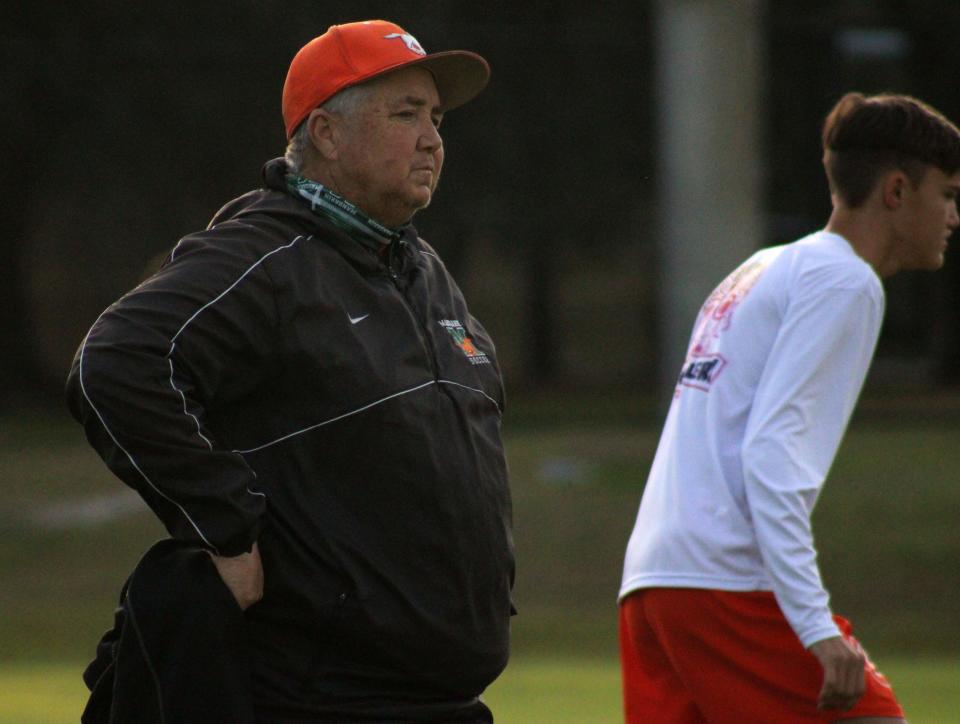 Mandarin soccer coach Jason Cooley observes practice before a game against Stanton. Cooley won his 300th game with Mustangs boys soccer.