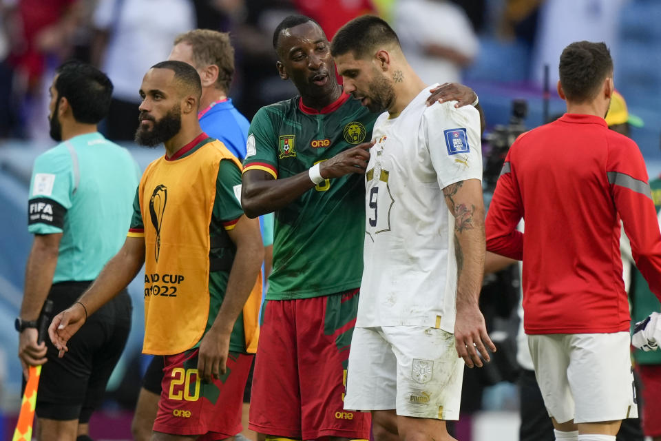 Cameroon's Gael Ondoua, left, talks to Serbia's Aleksandar Mitrovic after the World Cup group G soccer match between Cameroon and Serbia, at the Al Janoub Stadium in Al Wakrah, Qatar, Monday, Nov. 28, 2022. (AP Photo/Frank Augstein)