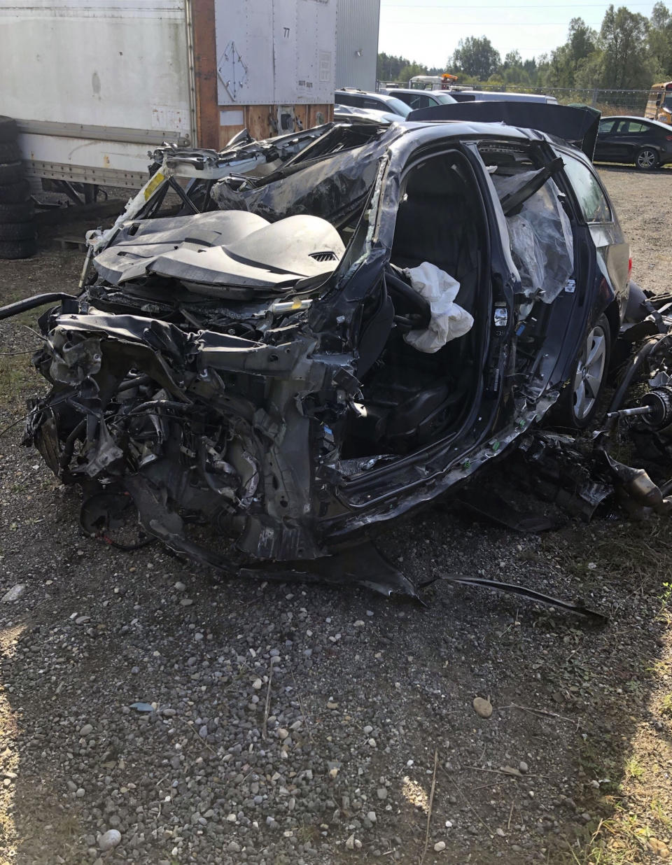 This Tuesday, Oct. 1, 2019 photo, released by the Ontario Provincial Police, shows the a smashed up vehicle involved in a fatal crash with transport truck near Shelburne, Ontario. Canadian police say the Jamaican dancehall reggae artist and actor known as Louie Rankin died Monday, Sept. 30, 2019, in the car crash involving a transport truck. (Ontario Provincial Police/The Canadian Press via AP)