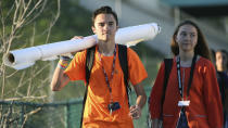 <p>Marjory Stoneman Douglas student David Hogg walks to school with a large rolled banner over his shoulder on Friday, April 20, 2018 in Parkland, Fla. (Photo: Amy Beth Bennett/South Florida Sun-Sentinel via AP) </p>