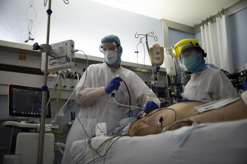 FILE - In this Wednesday, Oct. 21, 2020 file photo, medical staff work in the intensive care ward for COVID-19 patients at the CHR Citadelle hospital in Liege, Belgium. Small, yet so divided, Belgium is hit hard again by the pandemic, and now has some of the worst results to show in Europe during the resurgence of the Coronavirus, it is revealed Tuesday Oct. 27, 2020. (AP Photo/Francisco Seco, File)