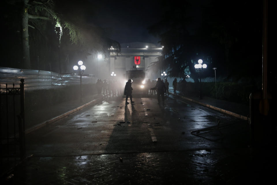 Policemen guard the parliament during an anti-government rally in Tirana, Albania, Saturday, April 13, 2019. Albanian opposition parties have gathered supporters calling for the government's resignation and an early parliamentary election. (AP Photo/Visar Kryeziu)