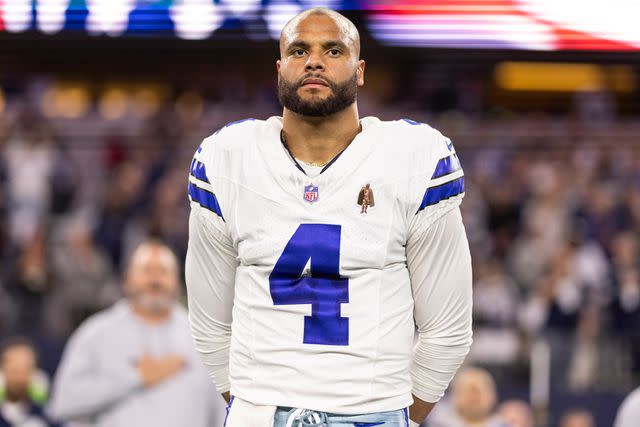 <p>Michael Owens/Getty</p> Dak Prescott #4 of the Dallas Cowboys looks on during the national anthem prior to an NFL football game between the Dallas Cowboys and the Seattle Seahawks at AT&T Stadium on November 30, 2023 in Arlington, Texas.