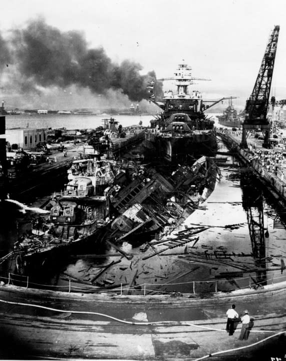 he wrecked destroyers USS Downes (DD-375) and USS Cassin (DD-372) in Drydock One at the Pearl Harbor Navy Yard, soon after the end of the Japanese air attack. Cassin has capsized against Downes. USS Pennsylvania (BB-38) is astern, occupying the rest of the drydock. The torpedo-damaged cruiser USS Helena (CL-50) is in the right distance, beyond the crane. Visible in the center distance is the capsized USS Oklahoma (BB-37), with USS Maryland (BB-46) alongside. Smoke is from the sunken and burning USS Arizona (BB-39), out of view behind Pennsylvania. USS California (BB-44) is partially visible at the extreme left. (This image has been attributed to Navy Photographer’s Mate Harold Fawcett. Official U.S. Navy Photograph, now in the collections of the National Archives)