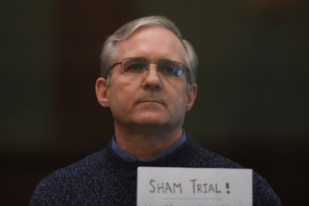 Paul Whelan, who remains imprisoned in Russia, is seen holding a sign protesting his criminal trial in Moscow after being accused of espionage. Whelan's family has said that former President Donald Trump didn't do anything to help secure his release.