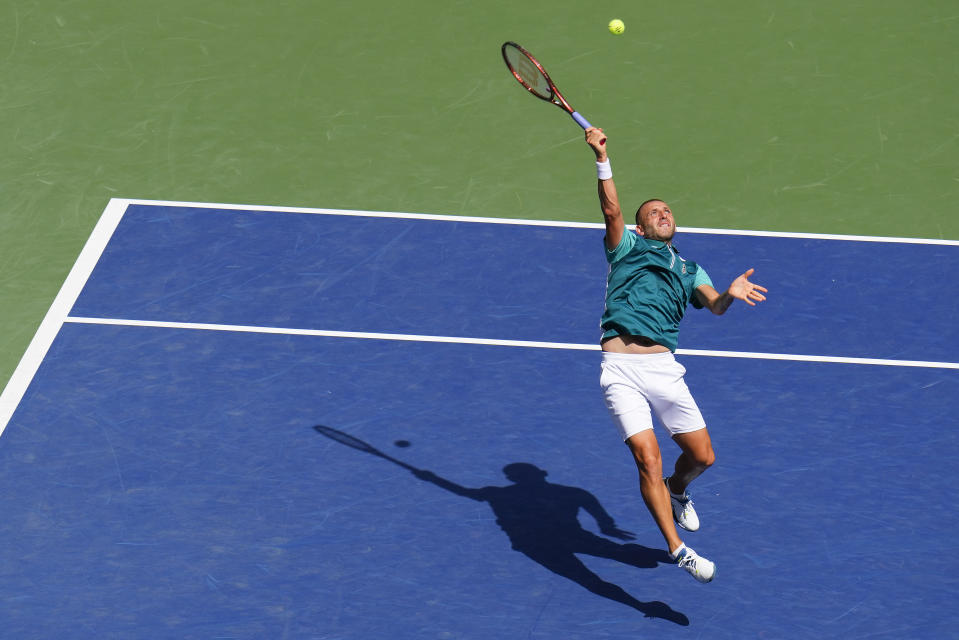 Daniel Evans, of the United Kingdom, returns a shot to Carlos Alcaraz, of Spain, during the third round of the U.S. Open tennis championships, Saturday, Sept. 2, 2023, in New York. (AP Photo/Manu Fernandez)