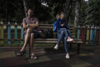 Parents Dmytro Roslyakov, and Karyna Ponomarenko, sit with their daughter 5-year-old Anhelina, in a playground as air raids go off, in Kramatorsk, eastern Ukraine, Thursday, July 14, 2022. It’s well known that many of the residents of eastern Ukraine who refuse to heed authorities’ calls to flee are older ones. It’s jarring, then, to explore the streets of communities close to the front line and spot children. Unlike the adults who decide to stay, the children have their fate tied to the wishes of their parents. (AP Photo/Nariman El-Mofty)