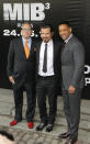 Director Barry Sonnenfeld, left, and actors Will Smith, right, and Josh Brolin pose for photographers at a cinema during a photocall for their film "Men in Black 3" in Moscow, Russia, Friday, April 18, 2012. The film premiere in Russia is scheduled for May 24. (AP Photo/Misha Japaridze)