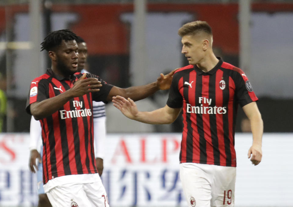 AC Milan's Franck Kessie, left, celebrates after scoring the opening goal with his teammate Krzysztof Piatek during the Serie A soccer match between AC Milan and Lazio, at the San Siro stadium in Milan, Italy, Saturday, April 13, 2019. (AP Photo/Luca Bruno)