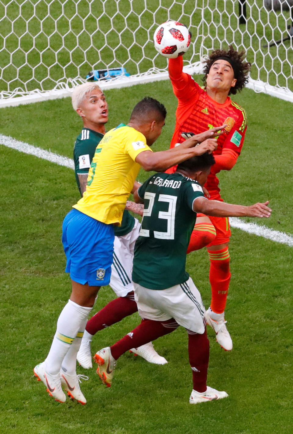 <p>Mexico’s Guillermo Ochoa punches the ball clear of Brazil’s Casemiro REUTERS/David Gray </p>