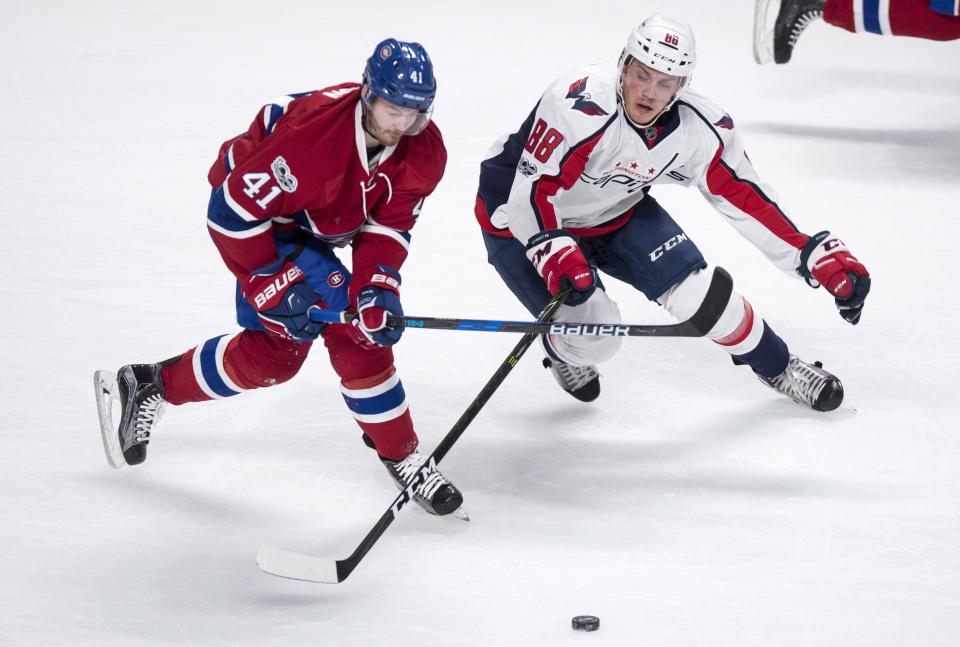 Montreal Canadiens left wing Paul Byron (41) and Washington Capitals defenseman Nate Schmidt (88) compete for the puck during the first period of an NHL hockey game Monday, Jan. 9, 2017, in Montreal. (Paul Chiasson/The Canadian Press via AP)