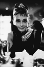 <p>What's more glamorous than Hepburn in this black dress, cigarette holder placed elegantly in hand, jewelry dripping from her neck as Holly Golightly in <em>Breakfast at Tiffany's</em>? She can look put-together yet convey loneliness so perfectly.</p>