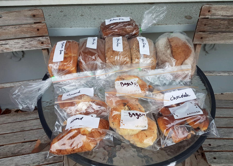 In this August 3, 2020 photo provided by Rick Everett, freshly baked loaves of bread and pastries sit outside Everett's home in Sydney, Australia, for friends and neighbors during the coronavirus pandemic. (Rick Everett via AP)