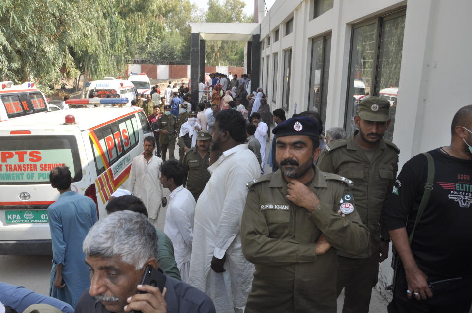 People gather outside a hospital where victims of a train fire admitted in Liaquatpur, Pakistan, Thursday, Oct. 31, 2019. A massive fire engulfed three carriages of the train traveling in the country's eastern Punjab province (AP Photo/Siddique Baluch)