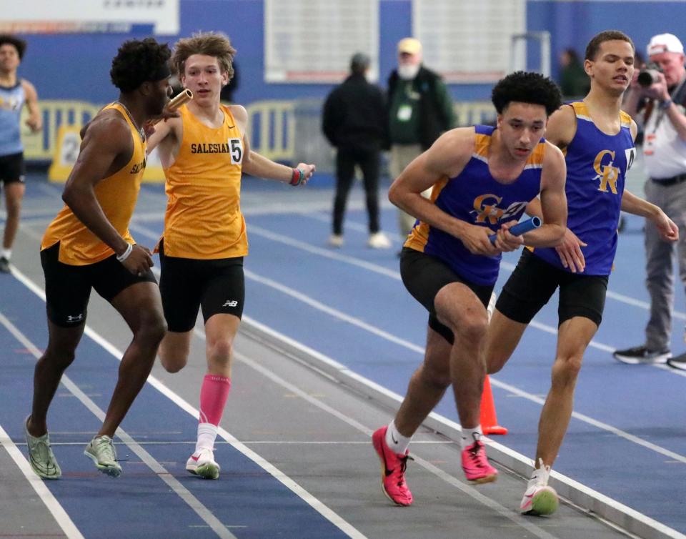 Caesar Rodney's Gabe Harris takes the final exchange from Ian Cain (right) in the 4x400 en route to a first place win as Salesianum's Bishop Lane (left) receives the baton from Ethan Walther during the DIAA indoor track and field championships at the Prince George's Sports and Learning Complex in Landover, Md., Saturday, Feb. 3, 2024.
