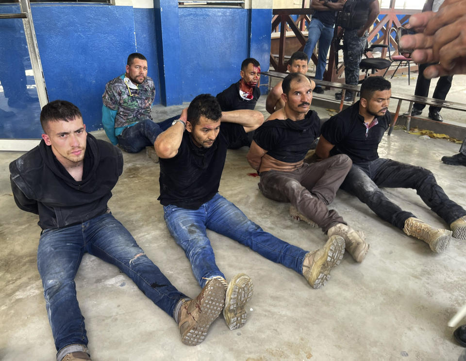 Suspects in the assassination of Haiti's President Jovenel Moise sit on the floor handcuffed after being detained, at the General Direction of the police in Port-au-Prince, Haiti, on Thursday, July 8, 2021.  / Credit: Jean Marc Hervé Abélard / AP