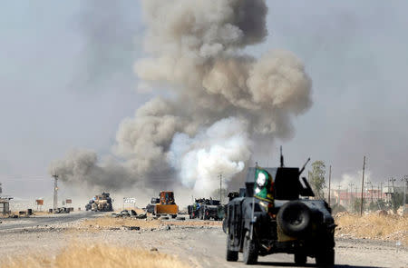 IED planted by Islamic States fighters explodes in front of Iraqi special forces vehicles in Bartella, east of Mosul. REUTERS/Goran Tomasevic