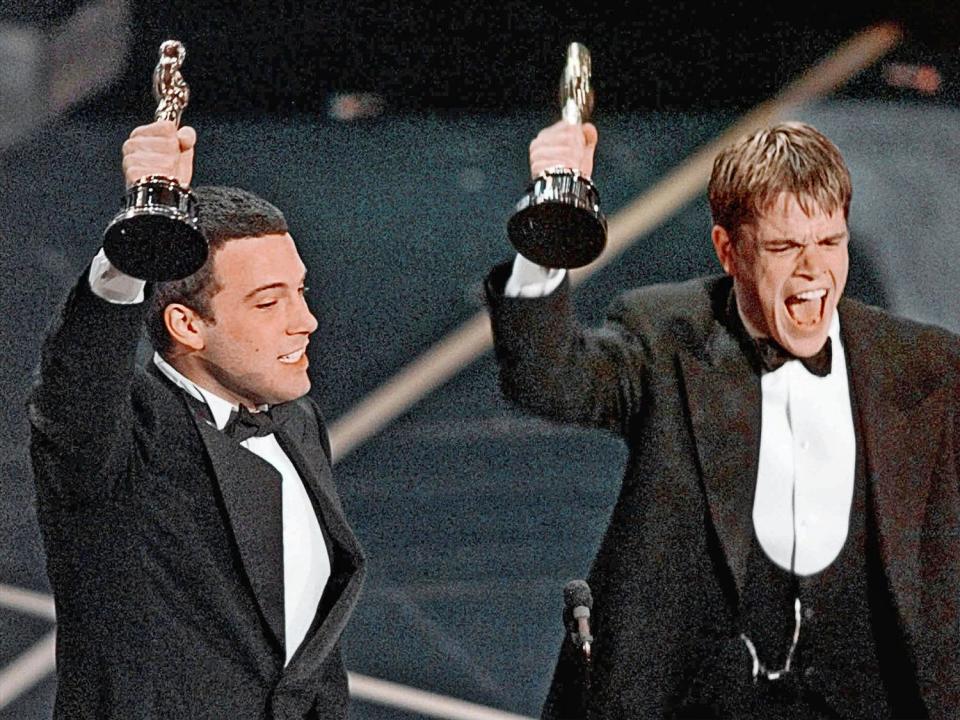 Ben Affleck and Matt Damon (l-r) react to winning Oscar for Best Original Screenplay for 