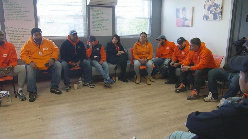 PHOTO: 'Peace Builders' speak with students who have dropped out of school at a meeting of the non-profit COMPASS Youth Collaborative's program. (ABC News)