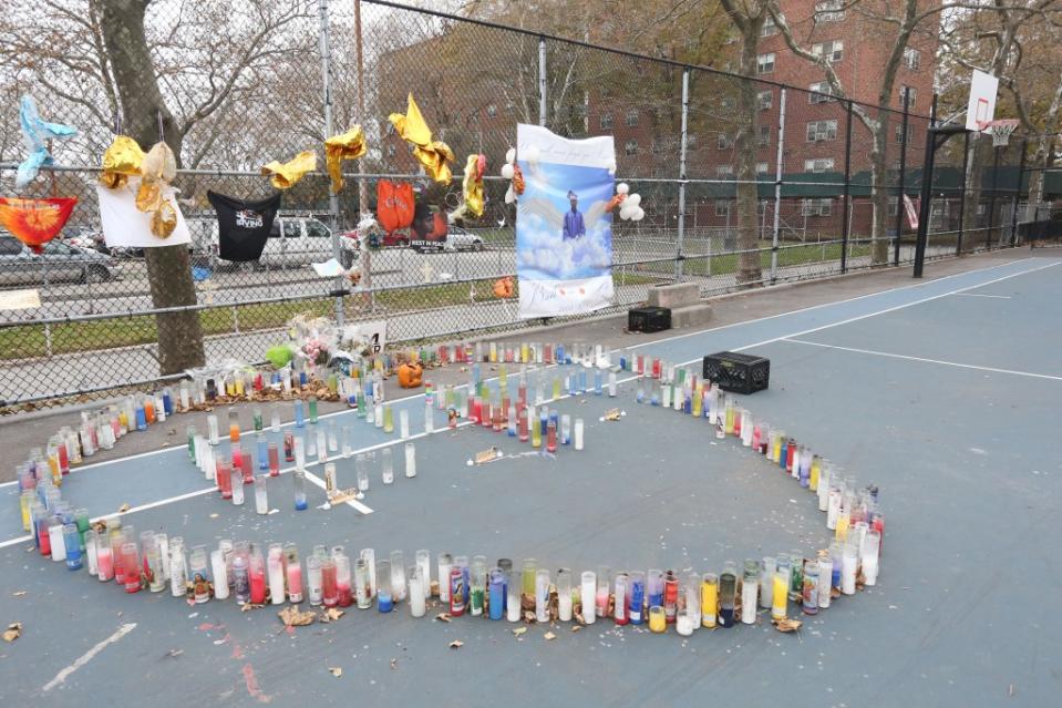 A collection of candles, notes and photos at the basketball courts at Baisley Park Houses in Jamaica, Queens, where Aamir Griffin was fatally shot. Dan Herrick