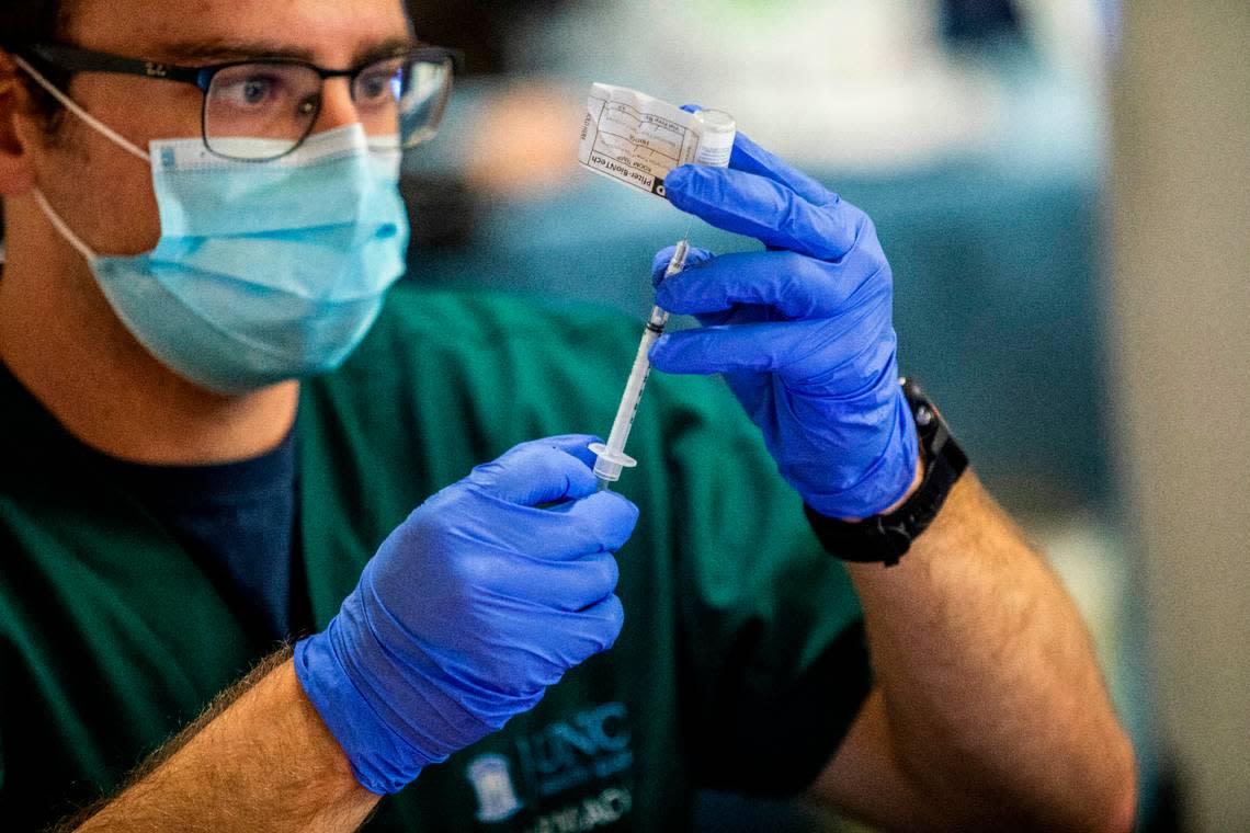 Pharmacy technician Cody Close prepares a dose of COVID-19 vaccine at UNC Health in Chapel Hill, NC Thursday, Dec. 17, 2020 where frontline healthcare workers are among some of the first recipients of the Pfizer COVID-19 vaccine.