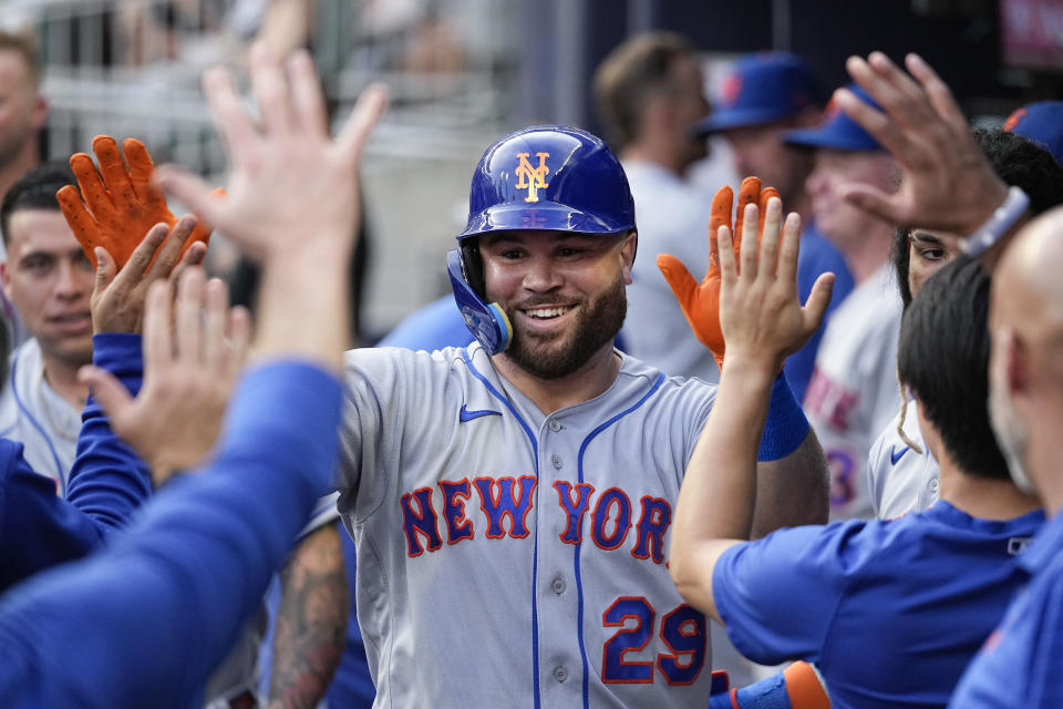 New York Mets right fielder DJ Stewart (29) celebrates in the dugout after hitting a home run in the second inning of a baseball game against the Atlanta Braves, Monday, Aug. 21, 2023, in Atlanta. (AP Photo/John Bazemore)