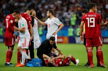 Soccer Football - World Cup - Group B - Iran vs Spain - Kazan Arena, Kazan, Russia - June 20, 2018 Iran's Saeid Ezatolahi receives treatment from medical staff after sustaining an injury REUTERS/Jorge Silva