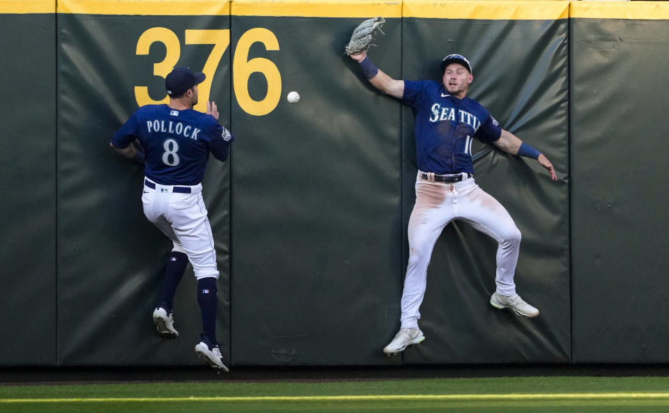 Seattle Mariners left fielder AJ Pollock (8) and center fielder Jarred Kelenic, right, can't come up with triple by Minnesota Twins' Alex Kirilloff during the fourth inning of a baseball game Tuesday, July 18, 2023, in Seattle. (AP Photo/Lindsey Wasson)