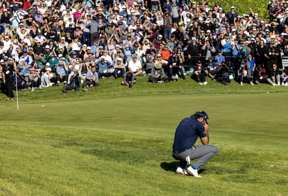 Second-place finisher Max Homa falls to his knees after his chip shot barely missed going into the hole on 18.