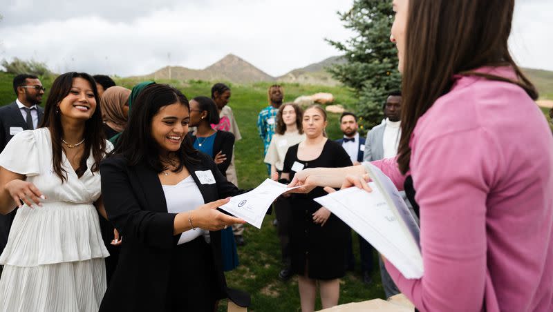 Director Elizabeth Zenger hands a certificate of graduation to Kabita Chhetri, of Nepal, during the One Refugee graduation celebration at the Garden Place at Heritage Park in Salt Lake City on May 8, 2023.