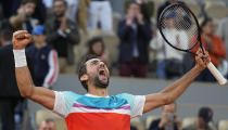 Croatia's Marin Cilic celebrates winning his quarterfinal match against Russia's Andrey Rublev in five sets, 5-7, 6-3, 6-4, 3-6, 7-6 (10-2), at the French Open tennis tournament in Roland Garros stadium in Paris, France, Wednesday, June 1, 2022. (AP Photo/Michel Euler)