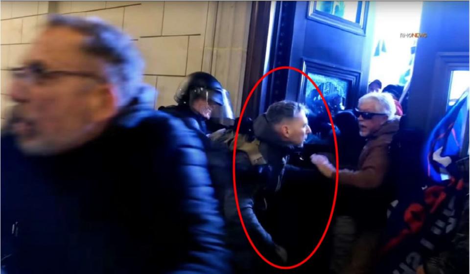 Marine Corps Major Christopher Warnagiris, seen here allegedly helping rioters breach the Capitol building on Jan. 6, 2021, now faces multiple federal charges for his role in the insurrection. (Photo: FBI)