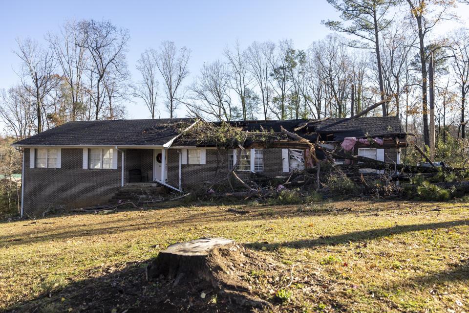 Part of Patti Beeker's house is damaged as a result of severe weather in the area, Wednesday, Nov. 30, 2022, in Eutaw, Ala. She woke her husband Steve just before a tree hit their house. Beeker quipped that she had been looking to renovate her kitchen, but not like this. (AP Photo/Vasha Hunt)