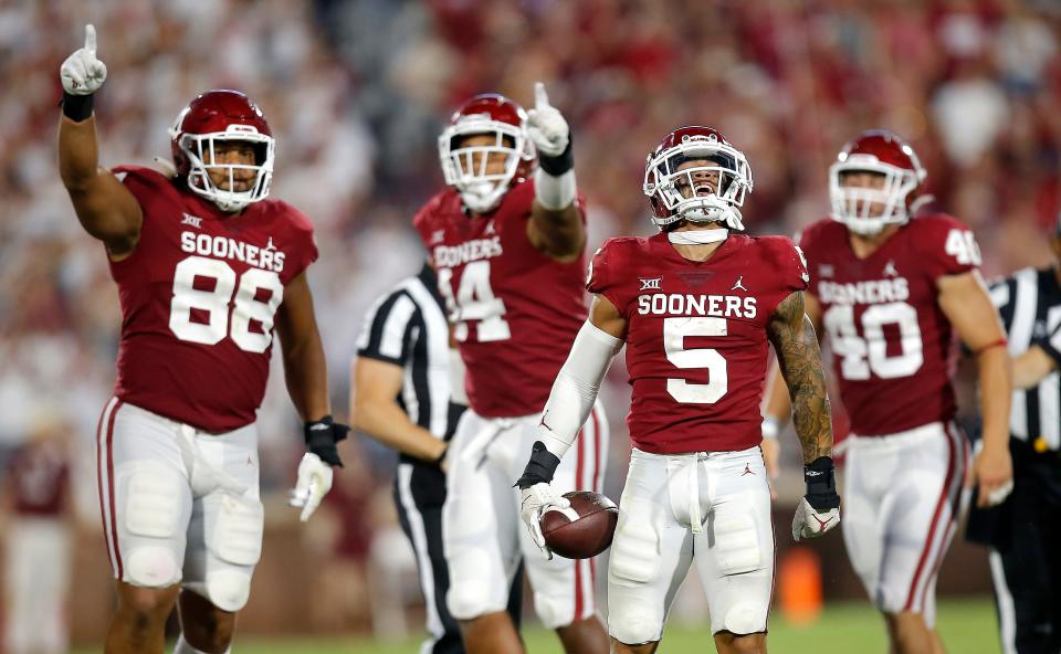 OU's Billy Bowman (4) celebrates a fumble with Jordan Kelley (88), Reggie Grimes (14) and Ethan Downs (40) in the third quarter of Saturday's win over Kent State.