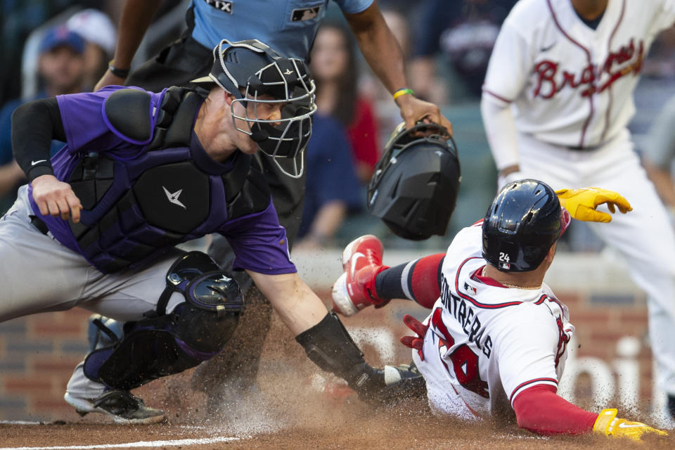 Colorado Rockies catcher Brian Serven left, makes the tag on Atlanta Braves William Contreras right, at home plate in the first inning of a baseball game Wednesday, Aug. 31, 2022, in Atlanta. (AP Photo/Hakim Wright Sr.)