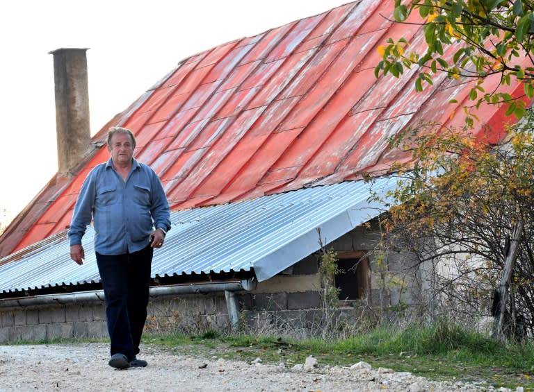 Dusko Mladic, cousin of Ratko Mladic, walks by his home, in the village of Bozanovici, near the town of Kalinovik, eastern Bosnia, on October 18, 2017