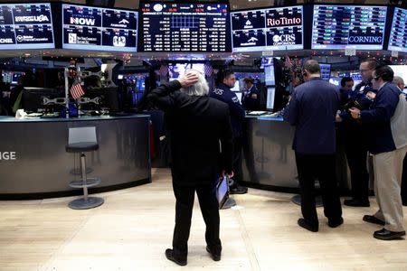 Traders work on the floor of the New York Stock Exchange (NYSE) in New York City, U.S., December 16, 2016. REUTERS/Brendan McDermid - RTX2VD7J