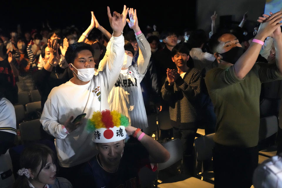 People celebrate Japan's victory against United States as they watch on a live stream of a World Baseball Classic (WBC) final being played at LoanDepot Park in Miami, during a public viewing event Wednesday, March 22, 2023, in Tokyo. (AP Photo/Eugene Hoshiko)