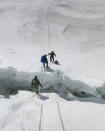 Climbers cross a part of Khumbu Icefall using a ladder at Everest April 28, 2016. Phurba Tenjing Sherpa/Handout via REUTERS