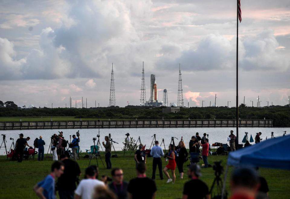 Members of the media photograph Artemis I during its launch countdown Monday from Kennedy Space Center, Fla. Launch of the rocket was scrubbed due to multiple issues.